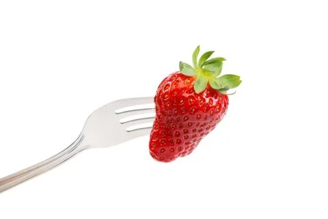 Fresh strawberry on a fork on white background. Stock Photos