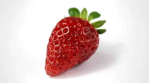 Fresh strawberry rotates on a white background Stock Footage 35472957