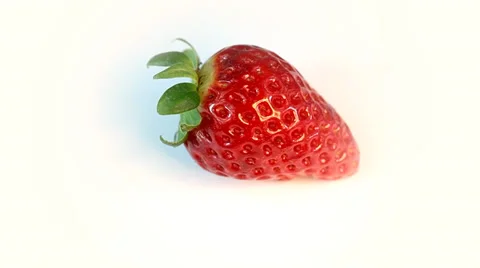 Fresh strawberry rotates on a white background Видео 35472968