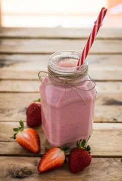 Fresh strawberry smoothie in a jar. white wooden background. Healthy detox.. Stock Photos