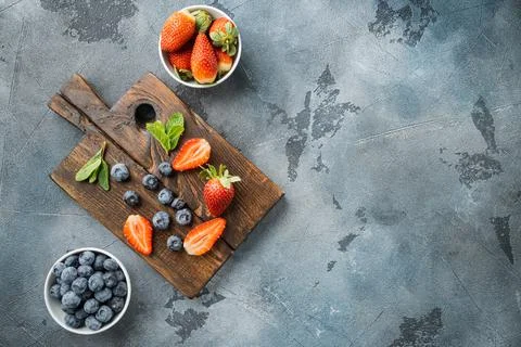 Fresh summer berries, on gray background, top view flat lay with copy space f Stock Photos