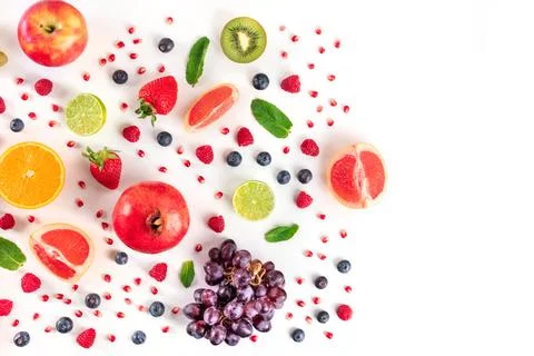 Fresh summer fruit, a flat lay on a white background, vibrant food pattern Stock Photos