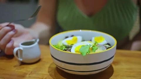 A fresh summer salad with boiled eggs, fresh herbs, sliced vegetables. Slow mo Stock-Footage 253086716