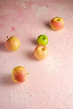 Fresh sweet apples on pink textured background, angle view Stock Photos