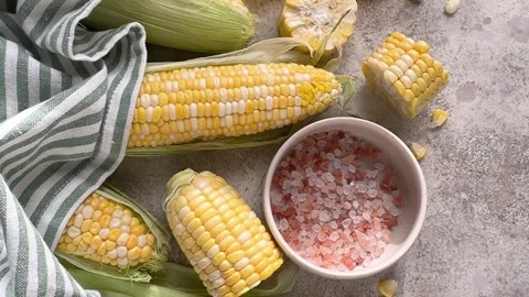 Fresh sweet corn cobs and pink salt Stock Footage 343968299