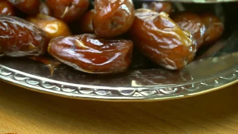 Fresh sweet dates on a silver platter for Ramadan Stock Footage 334137206