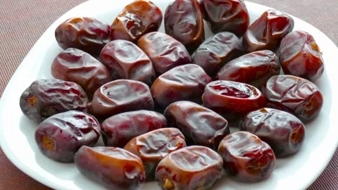 Fresh sweet dates on a white plate Stock Footage 333739210