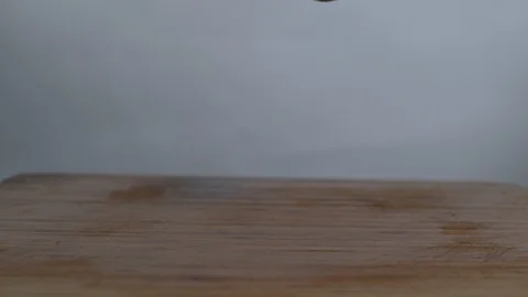 Fresh sweet lemon falling and bouncing on chopping board in slow motion Stock Footage 100009026