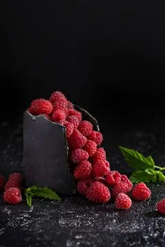 Fresh sweet raspberry in black cup Stock Photos