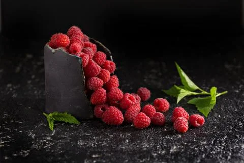 Fresh sweet raspberry in black cup Stock Photos