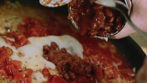 Fresh tabletop view of spooning tomato paste into seasoned beef Stock Footage 342153441