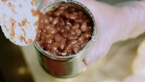 Fresh tabletop view of spooning tomato paste into seasoned beef Stock Photos