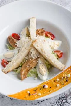 Fresh tasty caesar salad appetizer in white plate Stock Photos