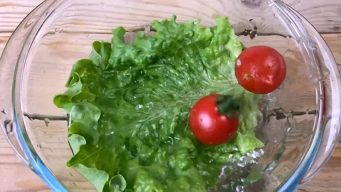 Fresh tasty tomatos cherry fall down in plate, plum tomatoes, super slow moti Stock Footage 148775722