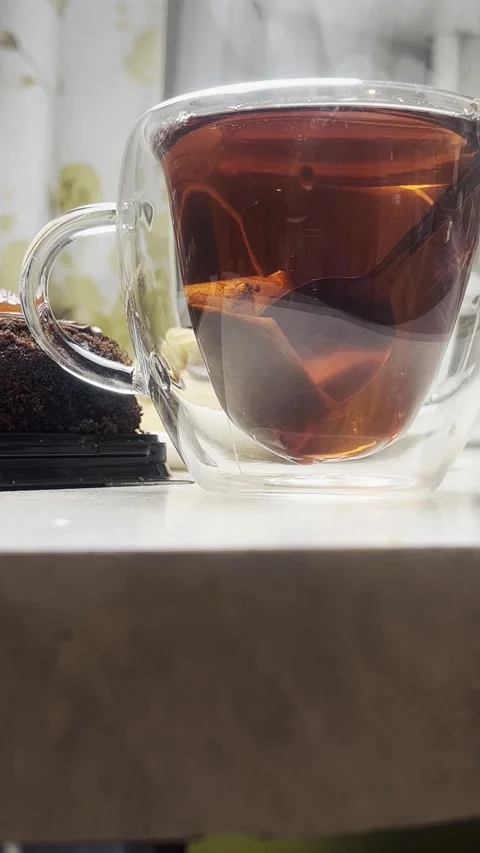 Fresh tea is brewed into a transparent cup. The lower point of the survey. Stock Footage 288672793