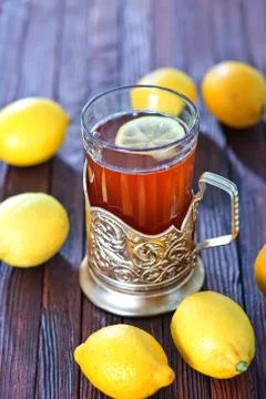 Fresh tea with lemon in cup on a table Stock Photos