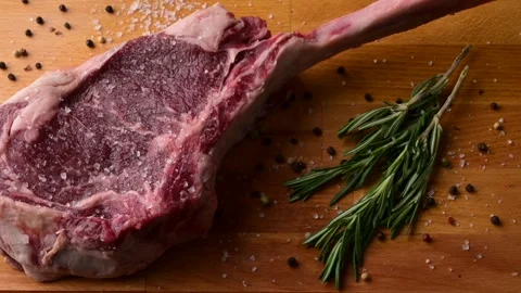 Fresh tomahawk steak on rustic board Stock Footage 269559712