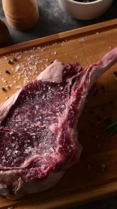 Fresh tomahawk steak on rustic board Stock Footage 269561693