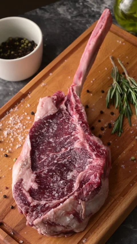 Fresh tomahawk steak on rustic board Stock Footage 269562062