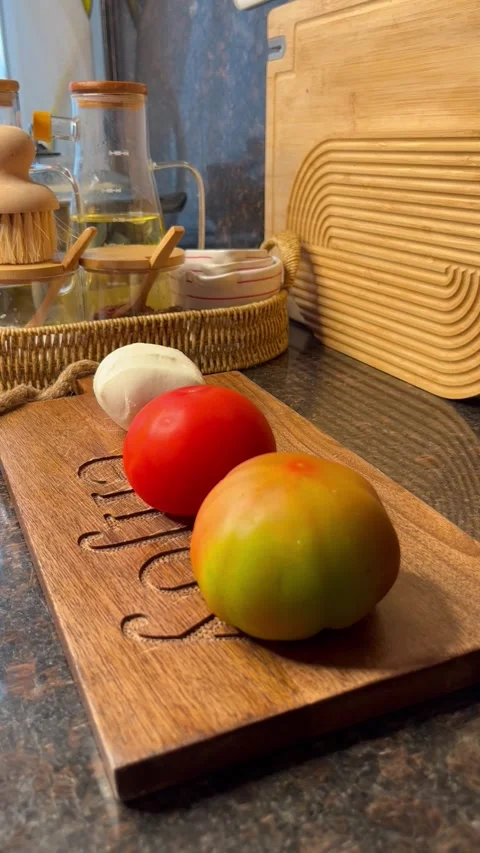 Fresh Tomato and Mozzarella Slicing on a Wooden Cutting Board in a Home Kitchen Stock Footage 342156533