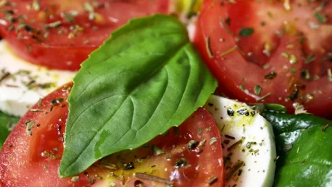Fresh tomato, basil and mozzarella Caprese salad circle rotation close up Stock Footage 278404372