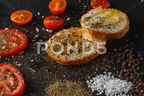 Fresh Tomato On Black Plate With Sea Salt On Background