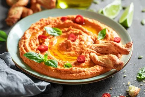 Fresh tomato hummus as red and healthy snack Stock Photos