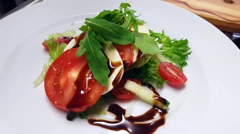 Fresh tomato mozzarella salad, including balsamico, rucola, cherry tomatoes a Stock Footage 63392937