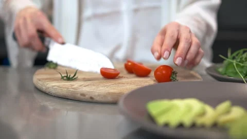 Fresh Tomato Preparation Techniques in a Modern Kitchen Setting for Delicious Stock Footage 293488090