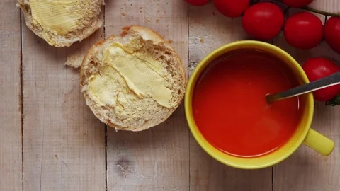 Fresh tomato soup with fresh bread and butter Stock Footage 166113855