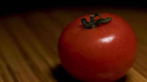 Fresh tomato is sprayed with water on the board. Stock Footage 104657595