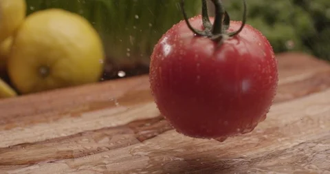Fresh tomato tomatoes bouncing onto cutting board 4 Stock Footage 123847261