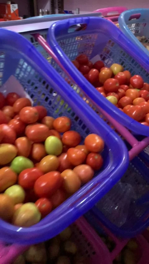 Fresh tomatoes and branded goods in local island shop Maldives vertical 库存影片 344602878