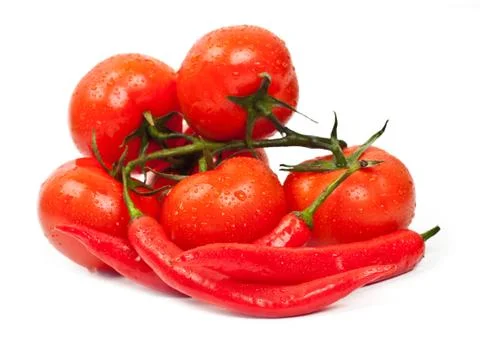 Fresh tomatoes and hot peppers Stock Photos