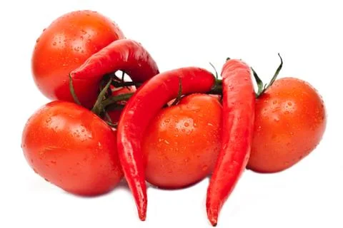 Fresh tomatoes and hot peppers Stock Photos