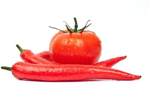 Fresh tomatoes and hot peppers Stock Photos