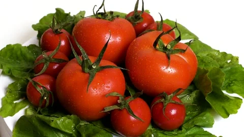 Fresh tomatoes and lettuce on a rotating plate Stock Footage 132861071