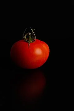 Fresh tomatoes on a black background close-up - Dark food photography Stock Photos