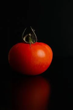 Fresh tomatoes on a black background close-up - Dark food photography Stock Photos