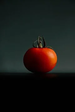 Fresh tomatoes on a black background close-up - Dark food photography Stock Photos