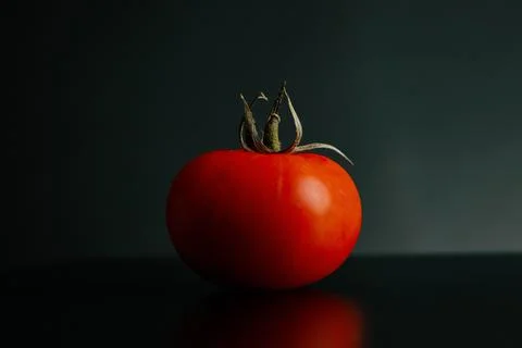 Fresh tomatoes on a black background close-up - Dark food photography Stock Photos