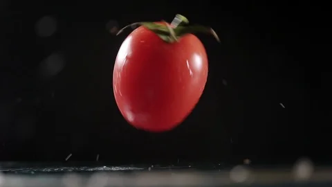 Fresh tomatoes closeup on black background Stock Footage 88575733