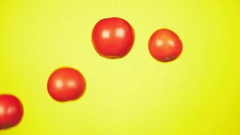 Fresh tomatoes fall with drops of water. The concept of nutrition. Stock Footage 95533681