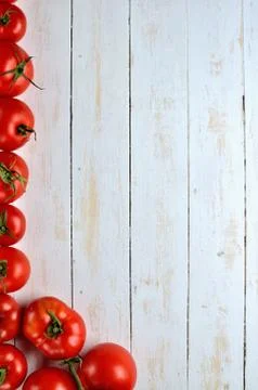 Fresh tomatoes frame on white rustic wooden background. Top view. Copy space Stock Photos