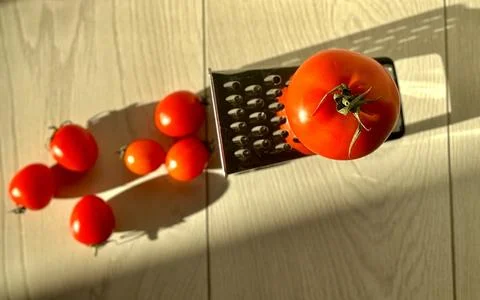 Fresh tomatoes with a grater on the table Stock Photos
