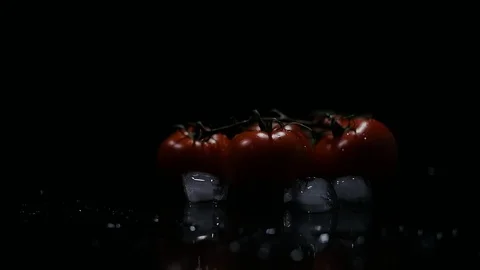 Fresh Tomatoes with ice cubes and drops water. Stock Footage 123313211