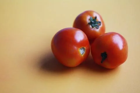 Fresh tomatoes on orange background Foto stock
