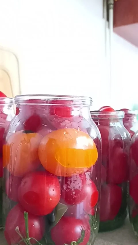 Fresh tomatoes packed in glass jars for homemade canning Видео 345326564