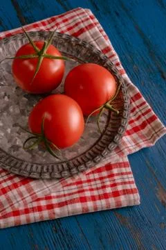 Fresh tomatoes in rustic style on a blue wooden background Foto stock