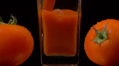 Fresh tomatoes. Super slow motion shot of pouring tomato juice into a Video stock 147413143
